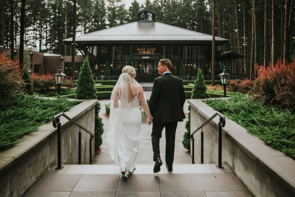 Bride and groom sharing a romantic moment at Shepherd’s Hollow Golf Club with a picturesque forest backdrop