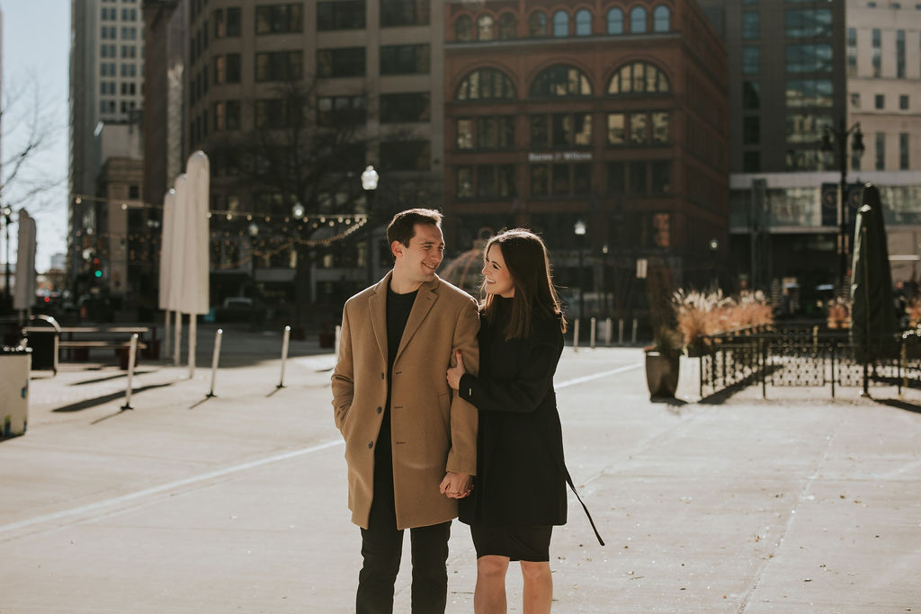 Engaged couple walking through Detroit city streets during Detroit Engagement Session Date Night.