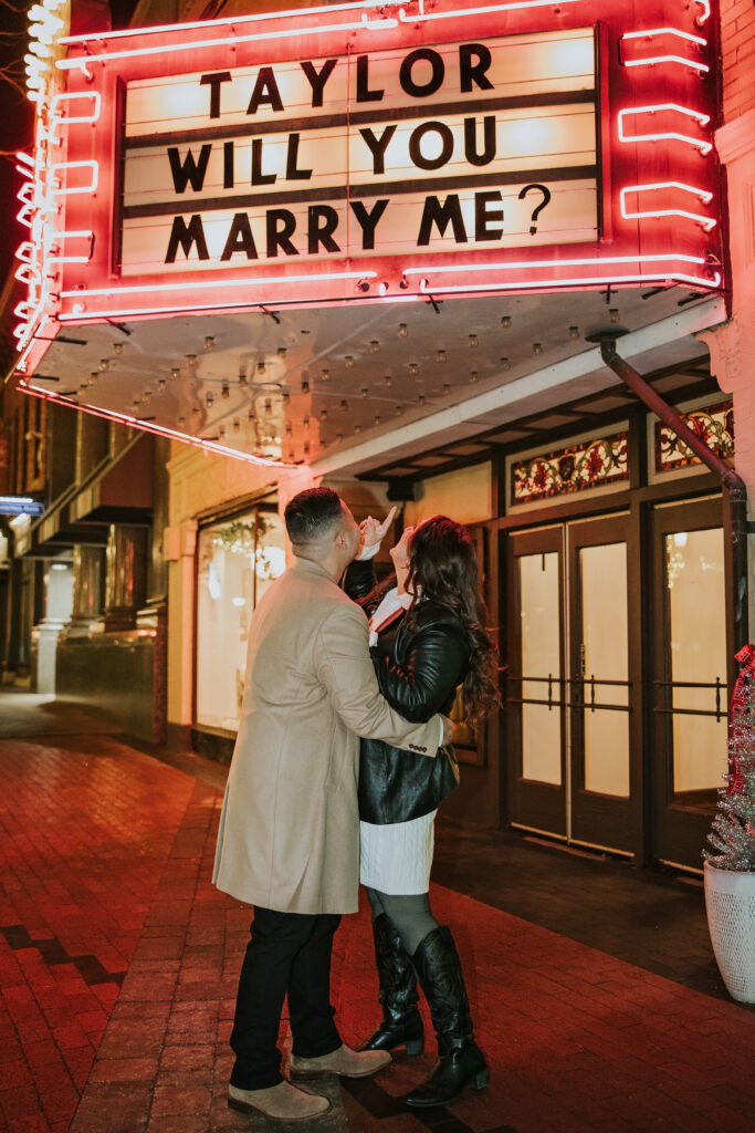 Engaged couple smiling ecstatically after the proposal in Northville