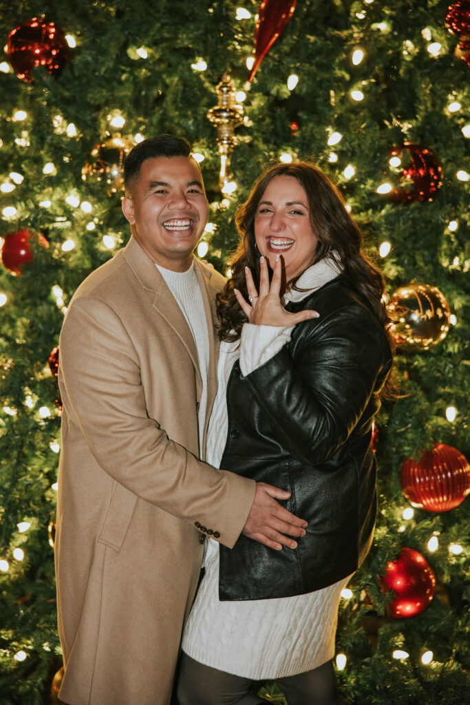 Engaged couple smiling ecstatically after the proposal in Northville