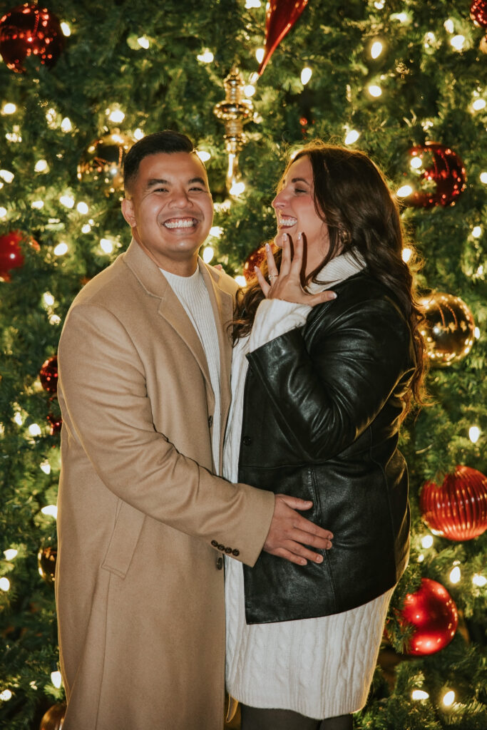 Engaged couple smiling ecstatically after the proposal in Northville