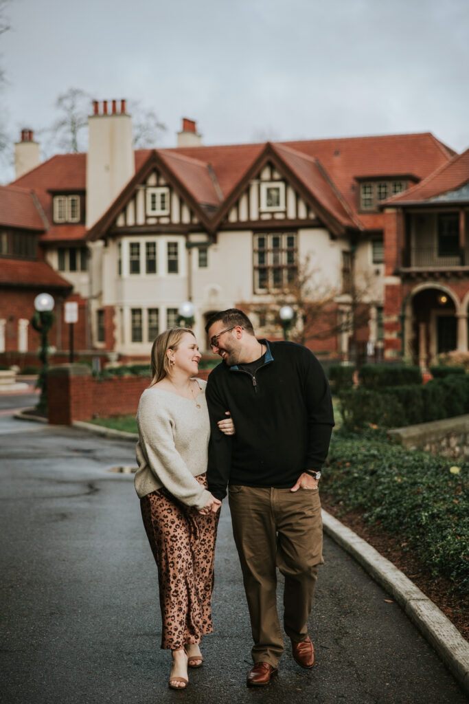 Couple laughing while walking through manicured gardens at Cranbrook.