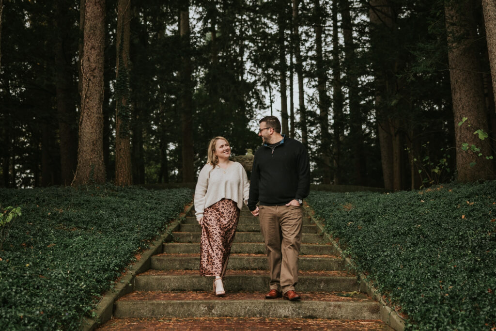 Couple walking together near the grand architecture of Cranbrook House.