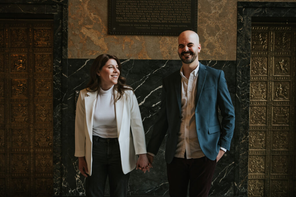 Fisher Building interior with a couple smiling for their Detroit engagement session.