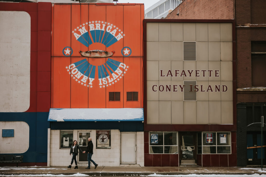 Detroit engagement session showcasing the iconic American Coney Island sign.