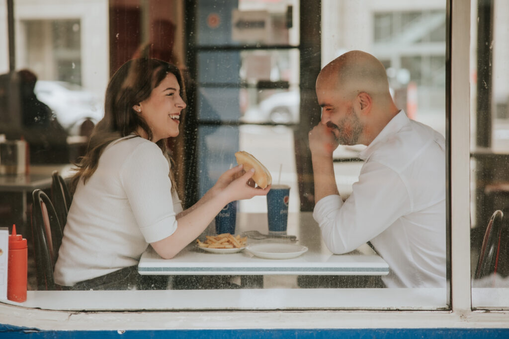 Couple sharing a chili dog at American Coney Island in Detroit.