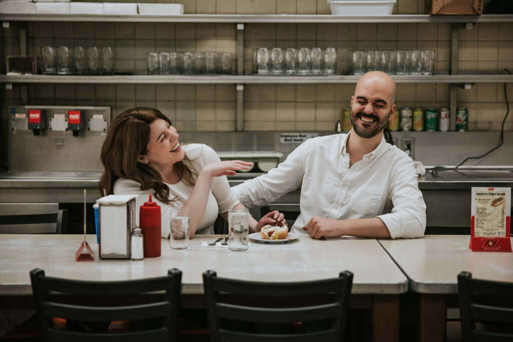 Couple enjoying hot dogs at Lafayette Coney Island in Detroit.