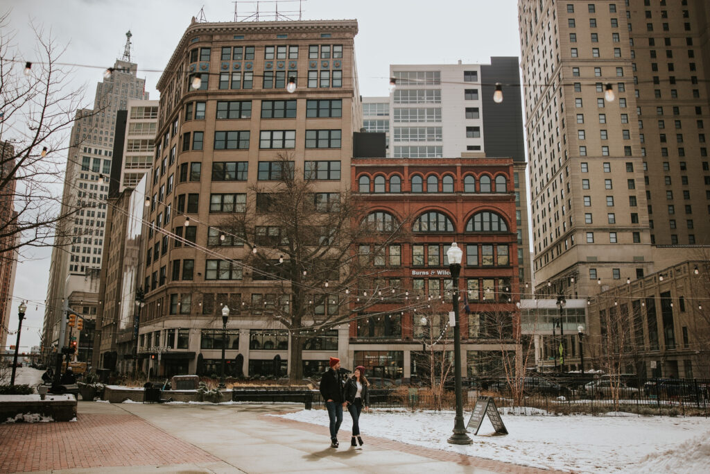 Couple walking the streets of Detroit during their winter engagement session.