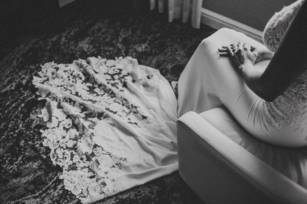 Close-up of bride’s elegant wedding dress, featuring intricate lace and design, captured at Lovett Hall.