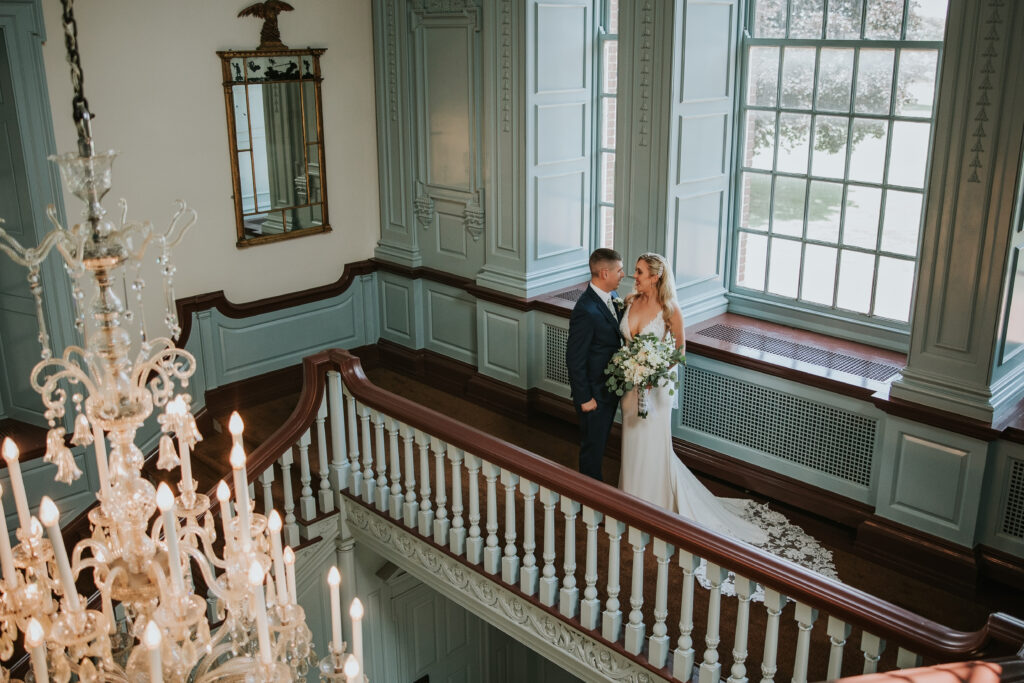 Romantic portrait of the bride and groom in the grand foyer of Lovett Hall, Henry Ford Museum.