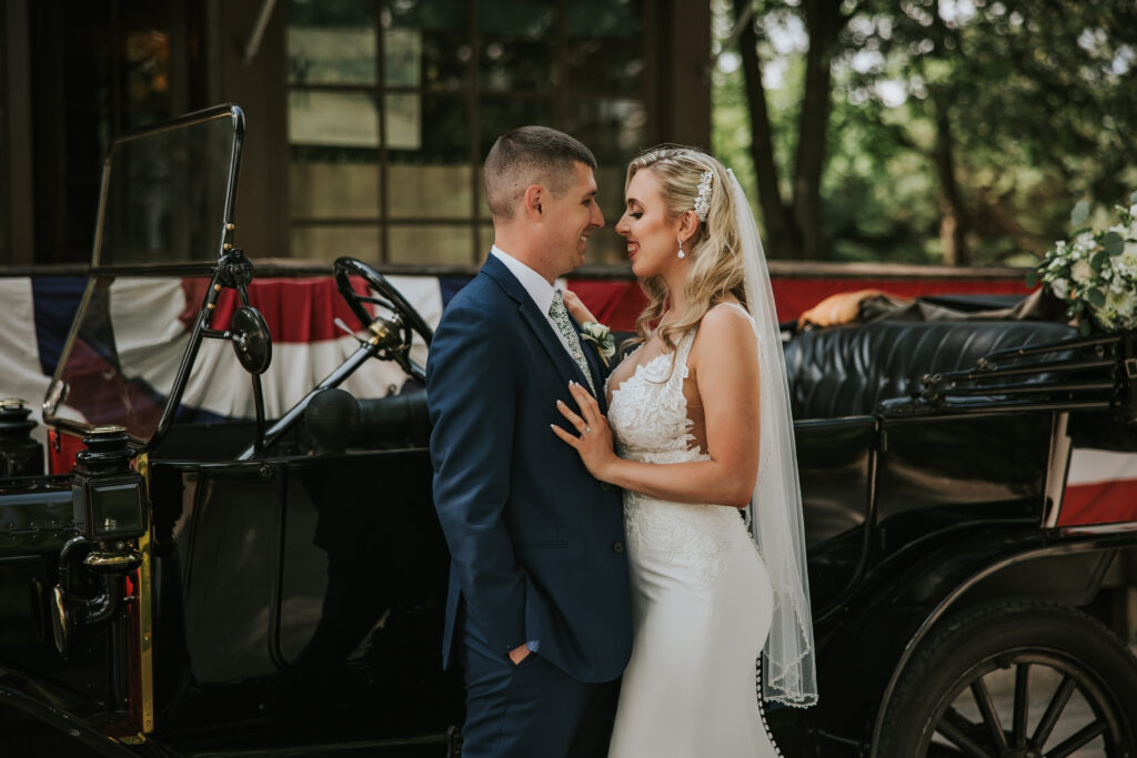 Romantic wedding moment between bride and groom in Greenfield Village, surrounded by historic charm and nature.