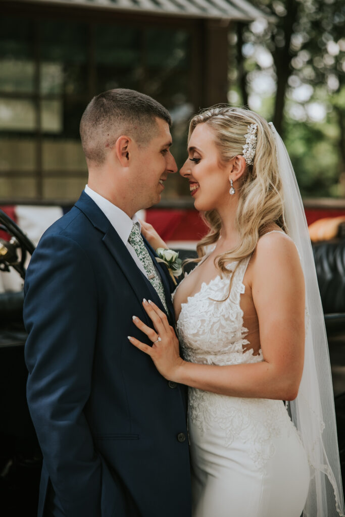 Newlyweds laughing together in Greenfield Village, capturing a romantic moment during their pre-ceremony portrait session.