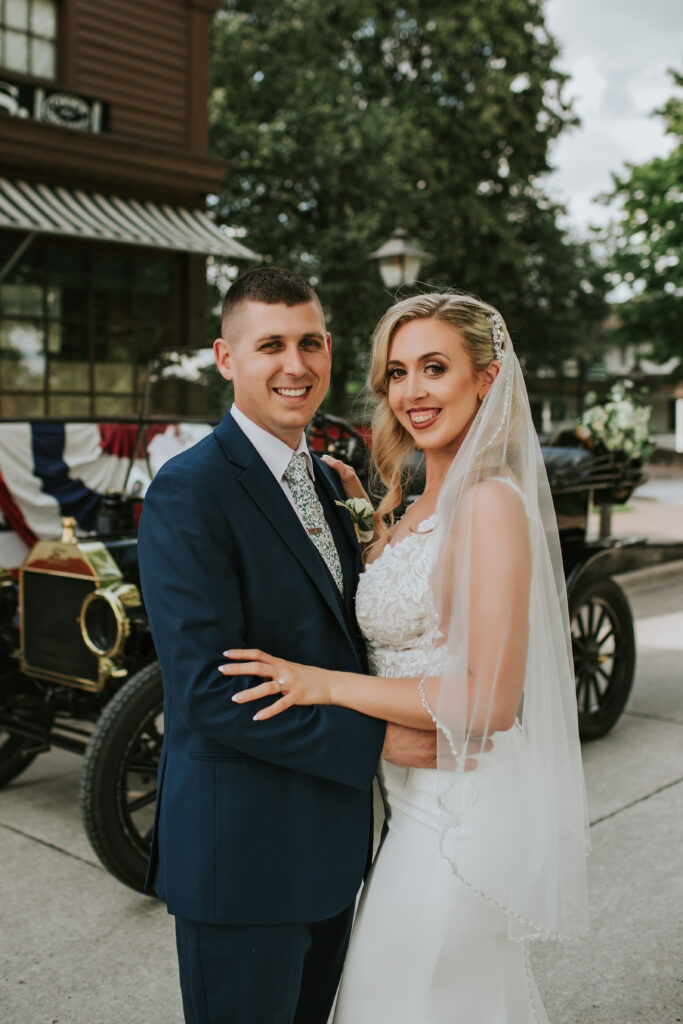 Romantic portrait of bride and groom smiling together in the beautiful surroundings of Greenfield Village, Michigan.