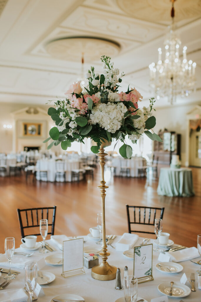 Close-up of elegant floral arrangements and wedding decor at the reception at Lovett Hall, Henry Ford Museum.