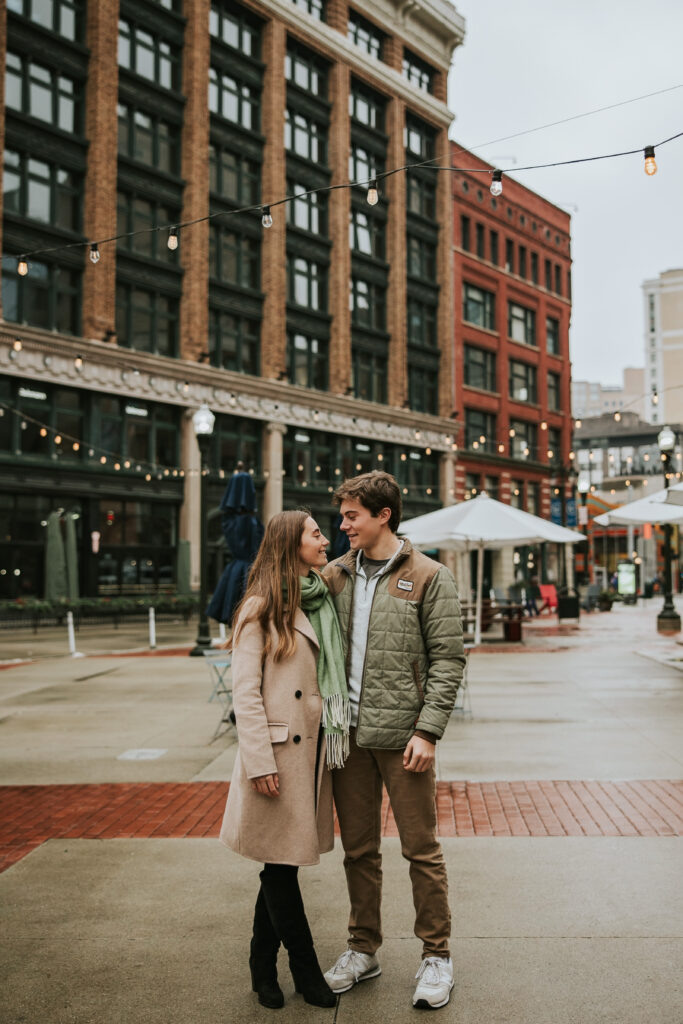 Rainy engagement photo in Capitol Park, capturing love and laughter between the couple.