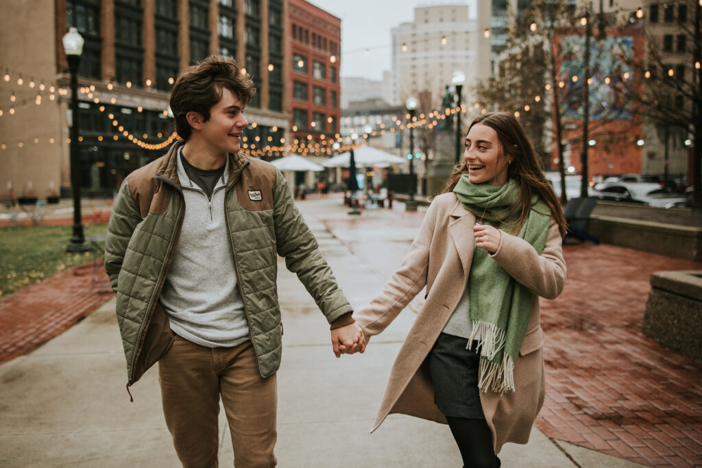 Couple enjoying a rainy day in Detroit, with Capitol Park in the background.