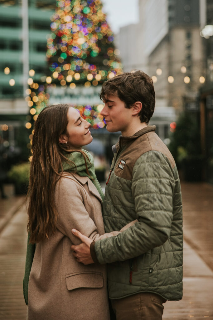 Engagement session at Cadillac Square, capturing the festive holiday vibes in the rain.