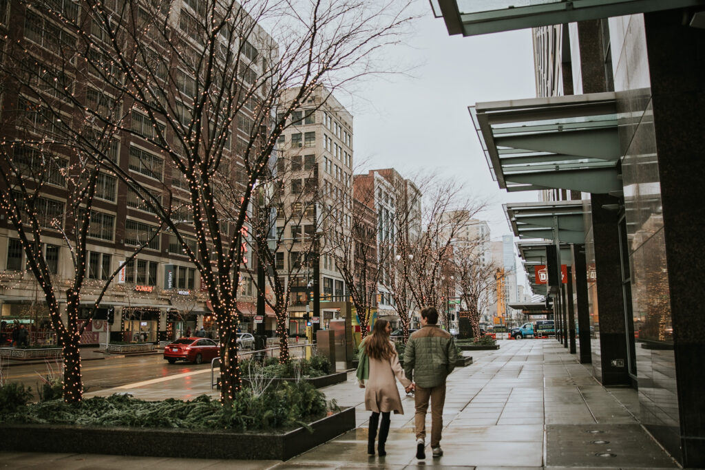 Couple walking through the rain, showcasing their love and connection in Detroit.