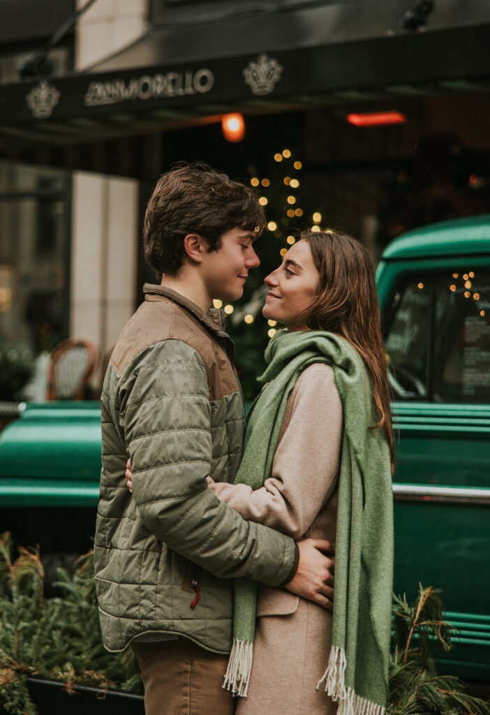 Kate and Tyler laughing and embracing the rainy weather during their engagement photos in Detroit.