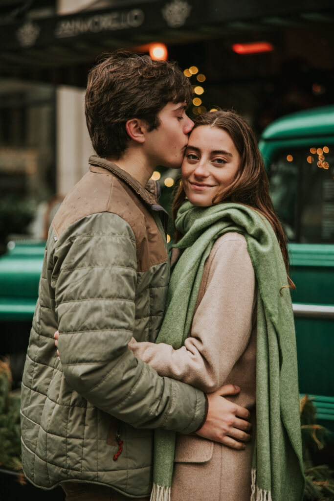 Loving couple braving the rain during their engagement photoshoot on Woodward Avenue, Detroit.