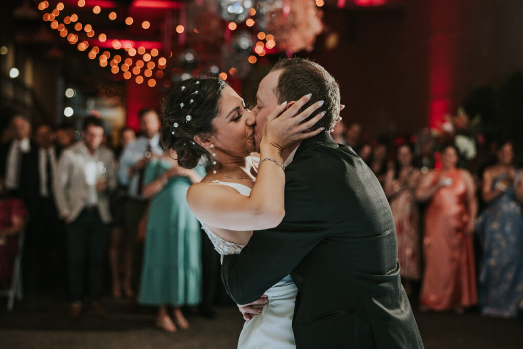 Bride and Groom share a kiss at the end of their first dance at their Waterview Loft Detroit summer wedding. 