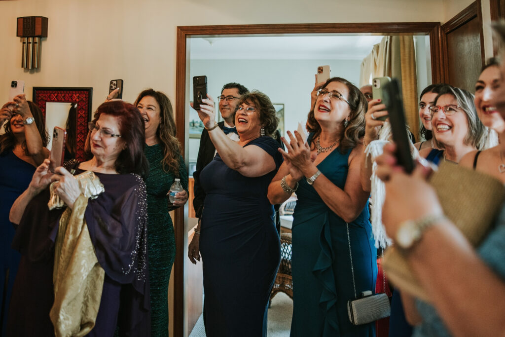 Bride celebrating with her family before the ceremony at Waterview Loft, Detroit.