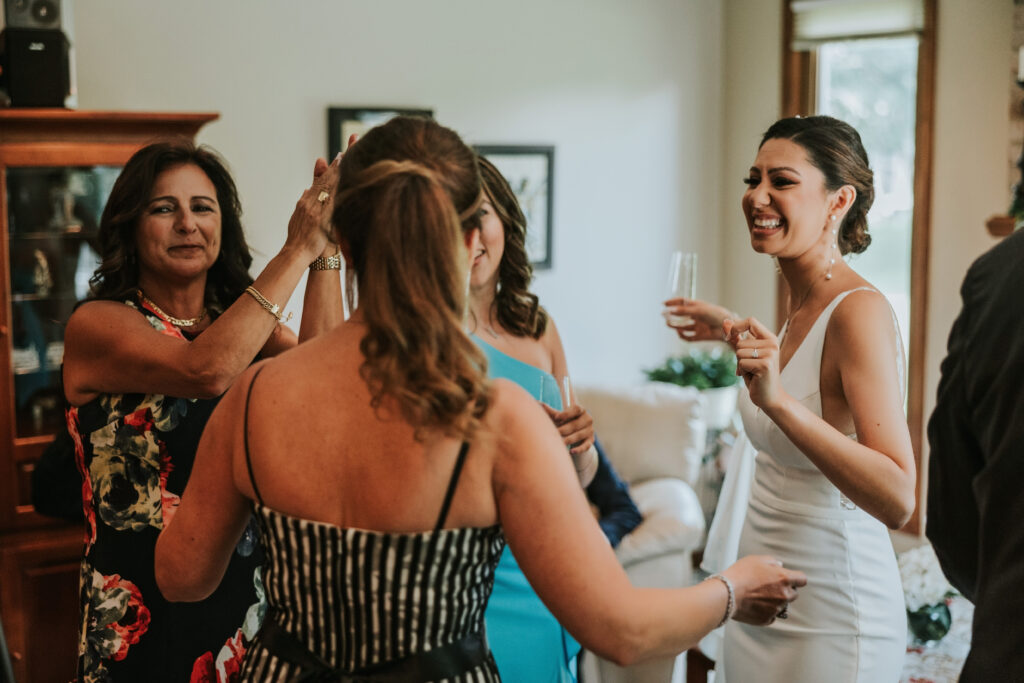 Bride surrounded by family and friends, celebrating before her wedding at Waterview Loft, Detroit.