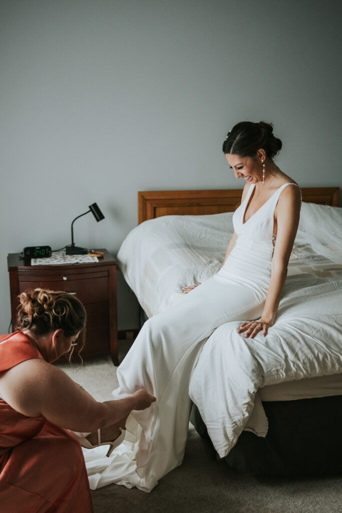 Bride putting on her shoes at Waterview Loft, Detroit wedding venue.