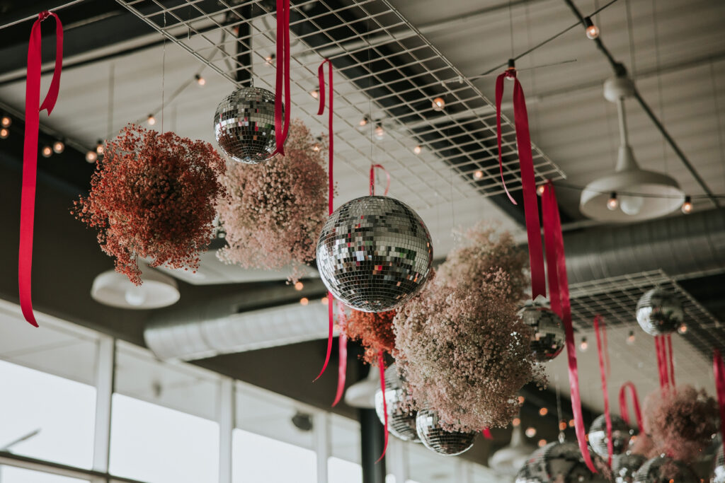 Bright wedding decor at Waterview Loft, Detroit with disco balls.