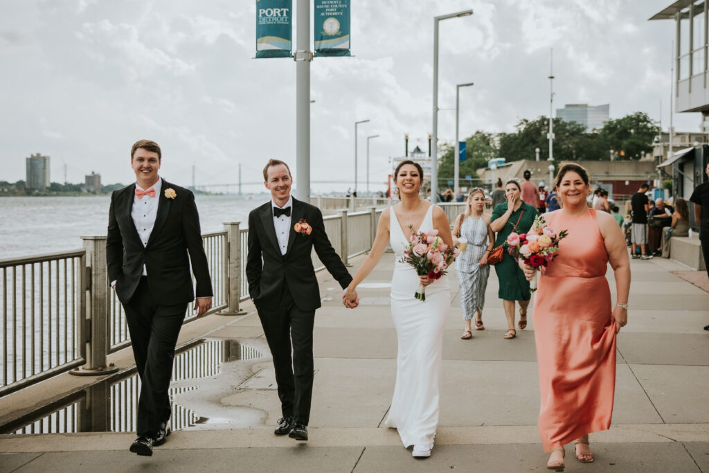 Bride and groom with their bridal party by the riverfront at Waterview Loft, Detroit.