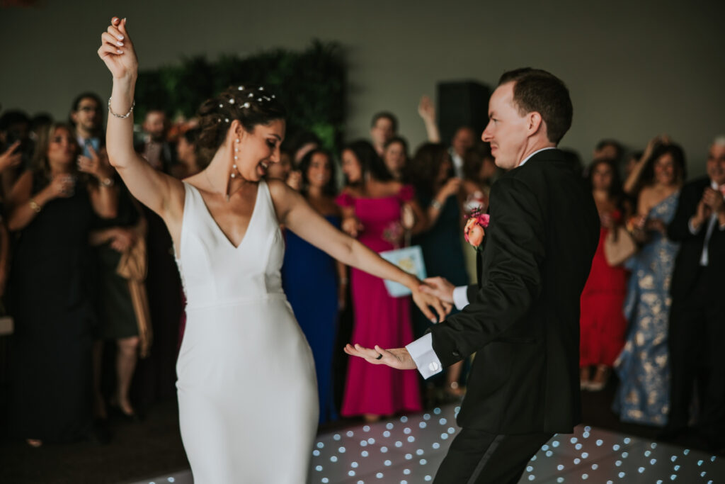 Bride and Groom surrounded by family on the dance floor at Waterview Loft, Detroit.