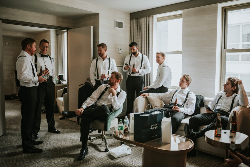 Groom and groomsmen sharing a moment before the Westin Book Cadillac wedding