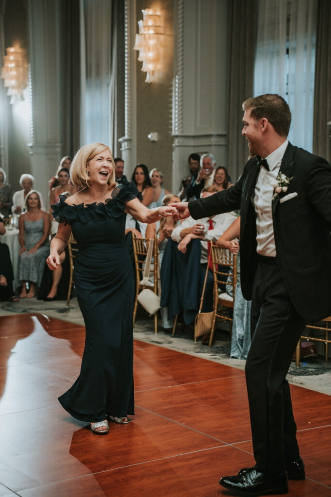 Groom enjoying parent dance during their Westin Book Cadillac wedding reception