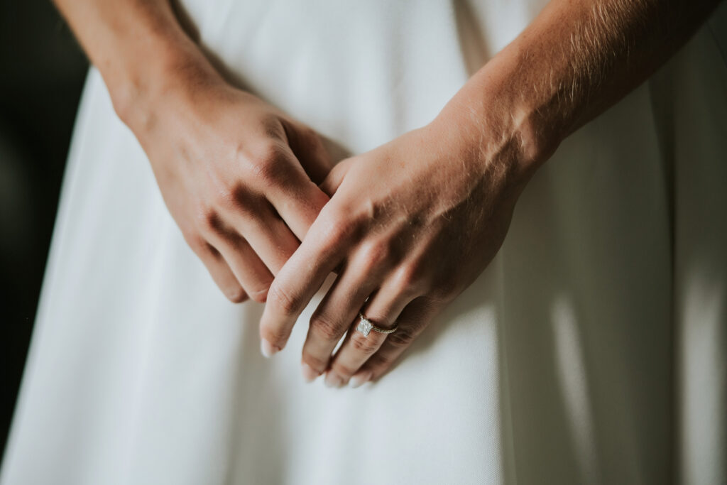 Close up of bride's hands and engagement ring before her Westin Book Cadillac wedding