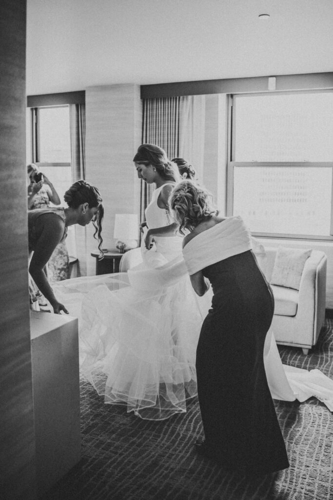 Bride getting dressed in a suite at the Westin Book Cadillac for her wedding day