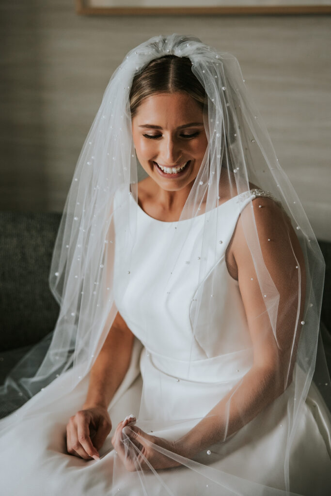 Bride laughing before her Westin Book Cadillac wedding