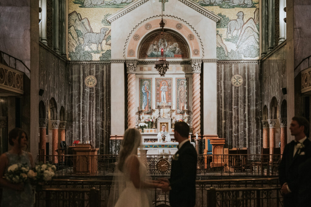 Bride and groom exchanging heartfelt vows during their St. Aloysius Church wedding ceremony