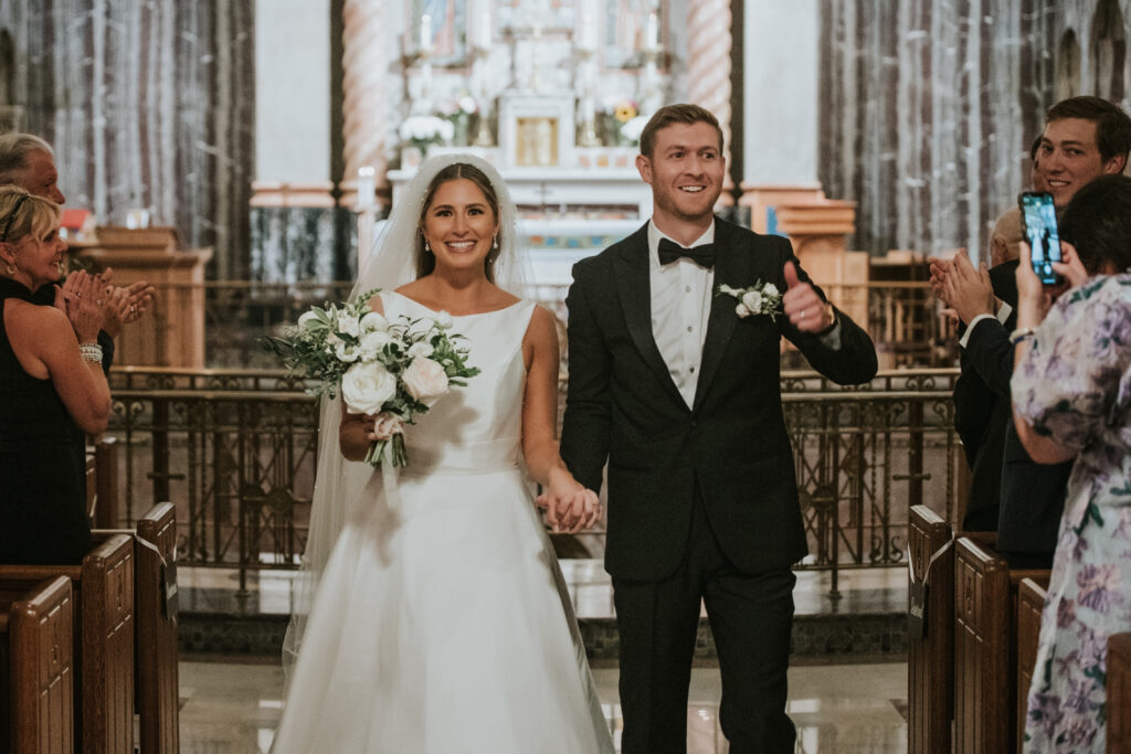 Couple walking down the aisle at St. Aloysius Church after their ceremony