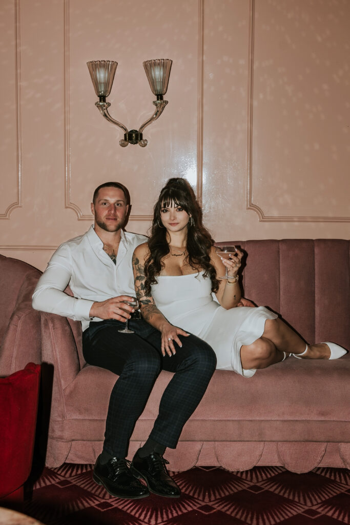 Intimate moment framed by vibrant, retro-inspired details at a Candy Bar Detroit Engagement session in a contemporary Detroit lounge.