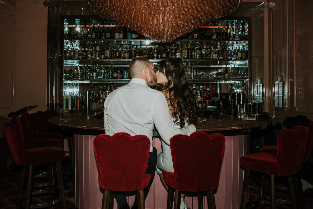 Wide-angle view of a couple enjoying their Candy Bar Detroit Engagement session, showcasing the upscale interior of a Detroit lounge.