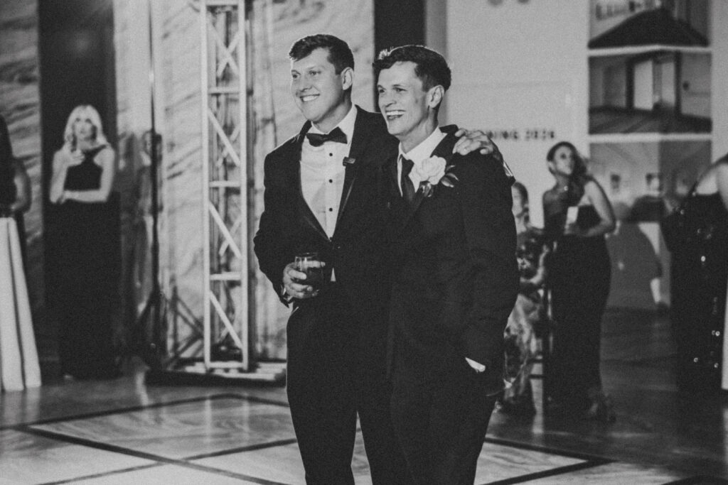 Groom and groomsmen sharing a toast during the reception.