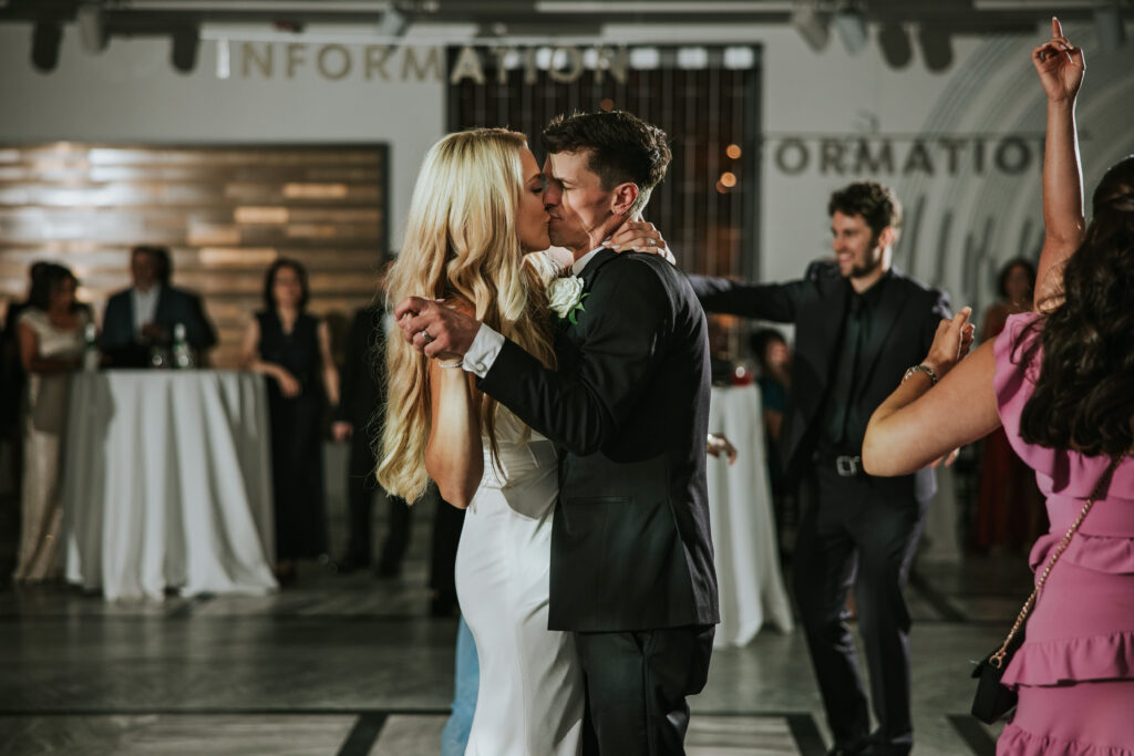 Couple sharing a kiss under the lights at the Detroit Institute of Arts.