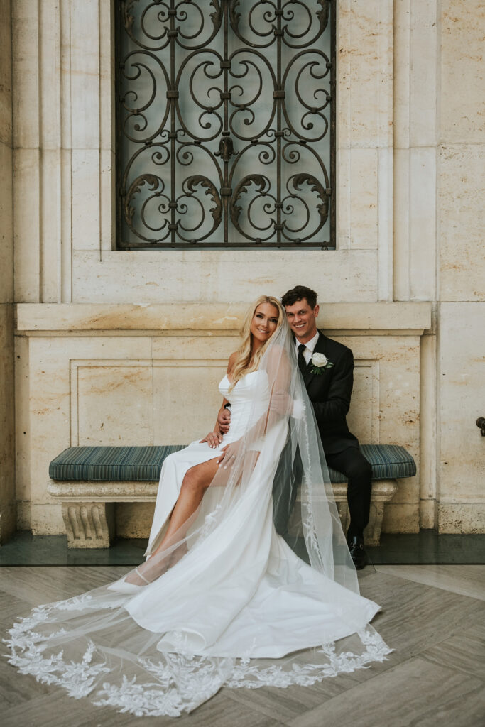 Bride and Groom smiling at the camera at the Detroit Institute of Arts