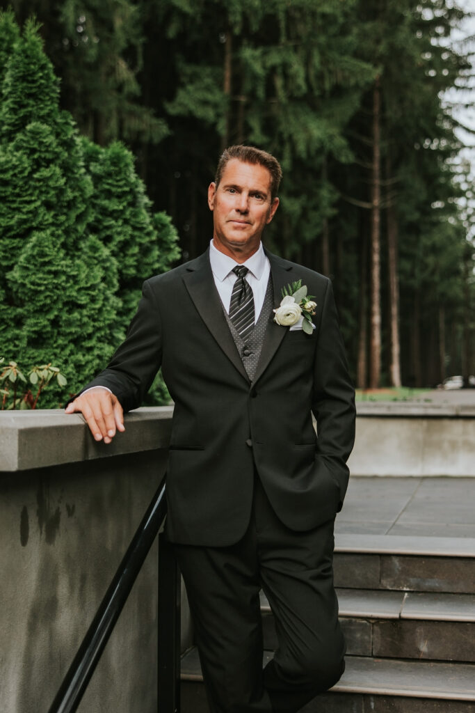 Handsome groom smiling for the camera at his Shepherd's Hollow wedding