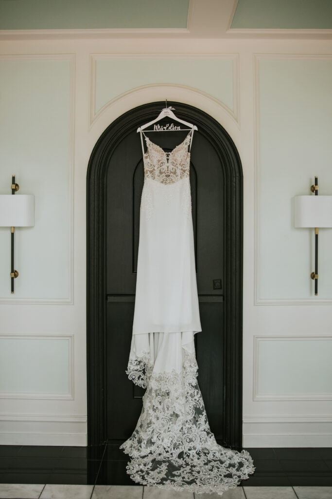 Wedding dress hung in front of a door at a Shepherd's Hollow wedding