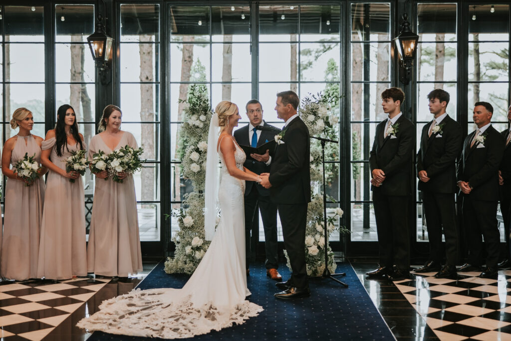 Wedding ceremony inside of Shepherd's Hollow Golf Club