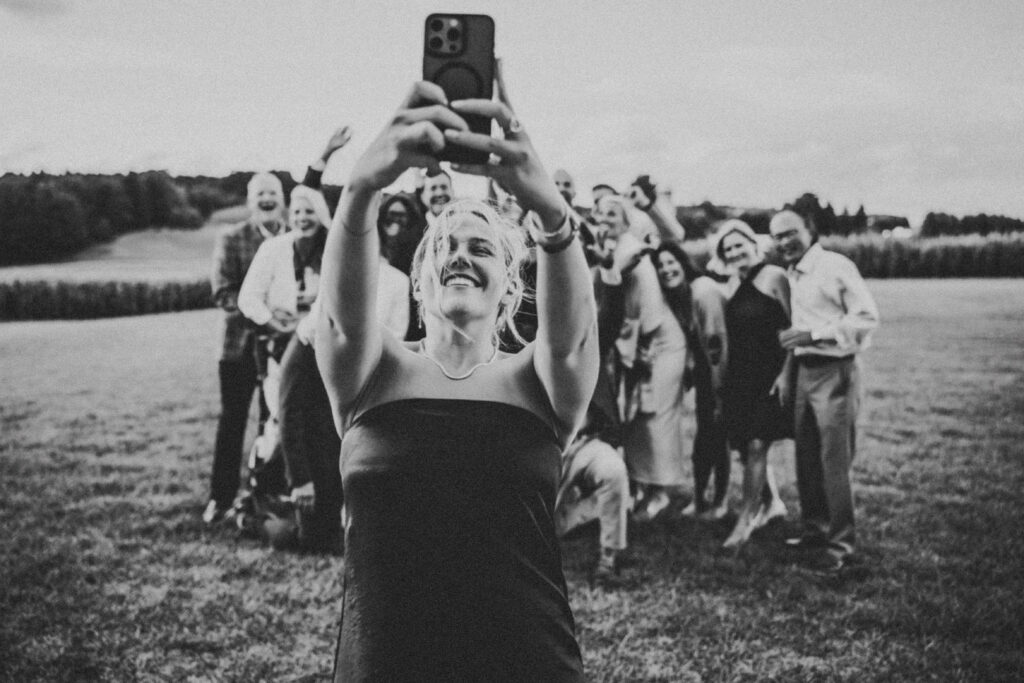 Wedding guest taking a selfie with friends at a Jacob's Farm Traverse City wedding