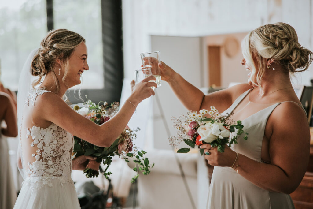 Bride toasting a bridesmaid at her Jacob's Farm Traverse City wedding