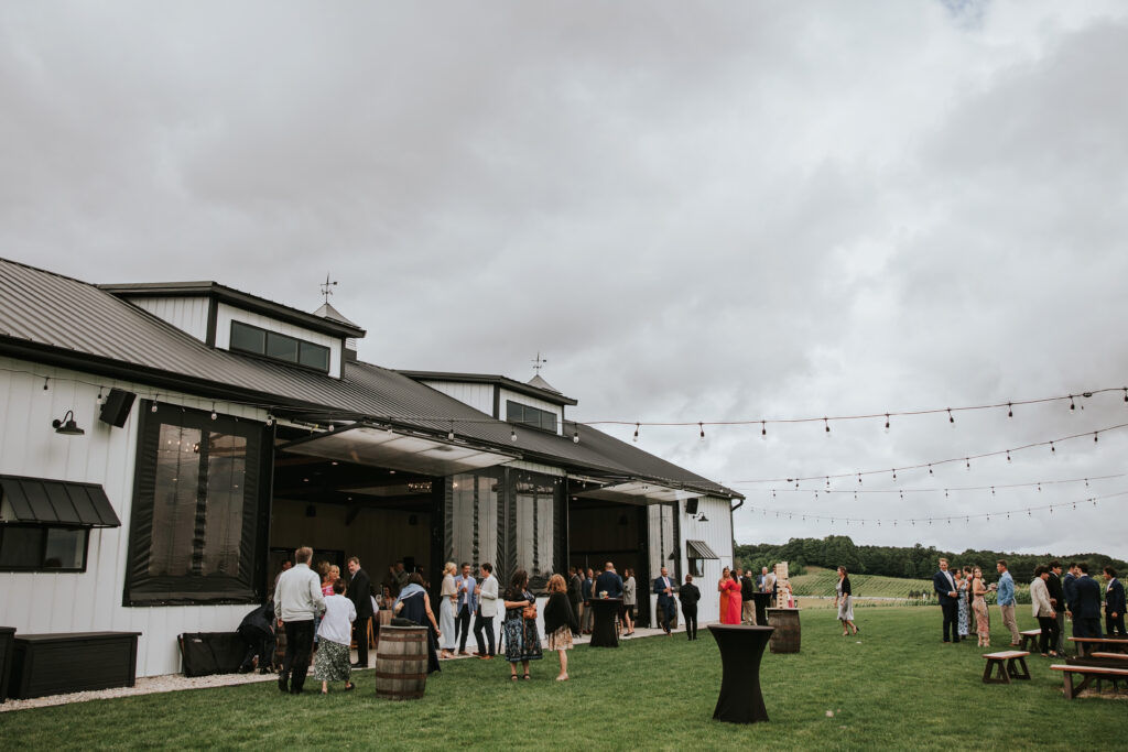 Guests enjoying cocktail hour at Jacob's Farm, Traverse City rustic charm.