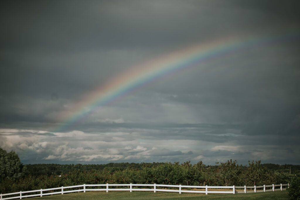 Vibrant rainbow over Jacob's Farm, a perfect backdrop for Traverse City weddings.